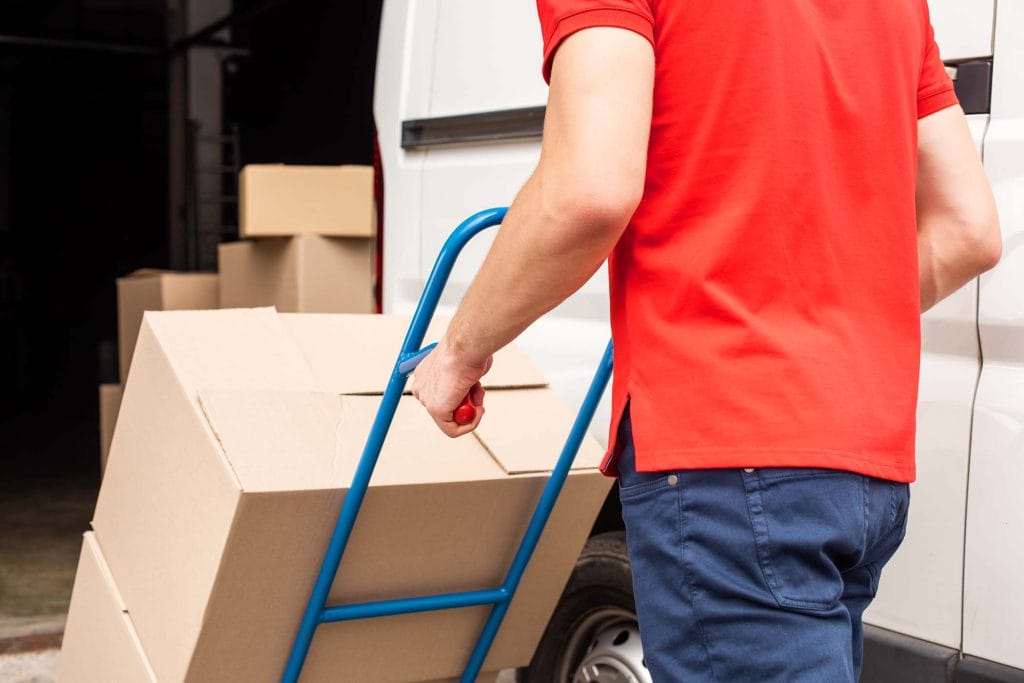 cropped shot of delivery man with cardboard boxes R4LYECP